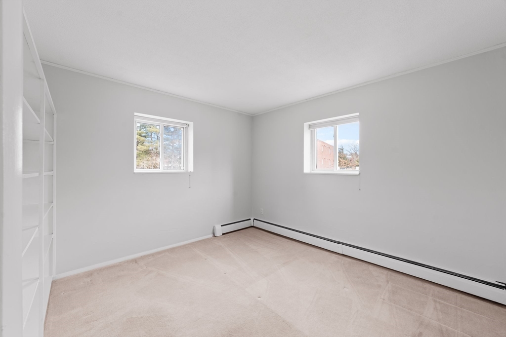 26 Westgate Road, Unit 264 Chestnut Hill, MA 02467 - Photo 18 of 30 an empty room with windows