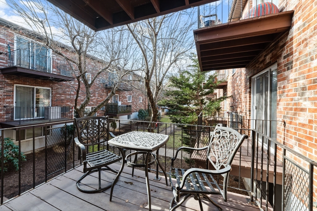 26 Westgate Road, Unit 264 Chestnut Hill, MA 02467 - Photo 28 of 30 a view of a chairs and table in the patio