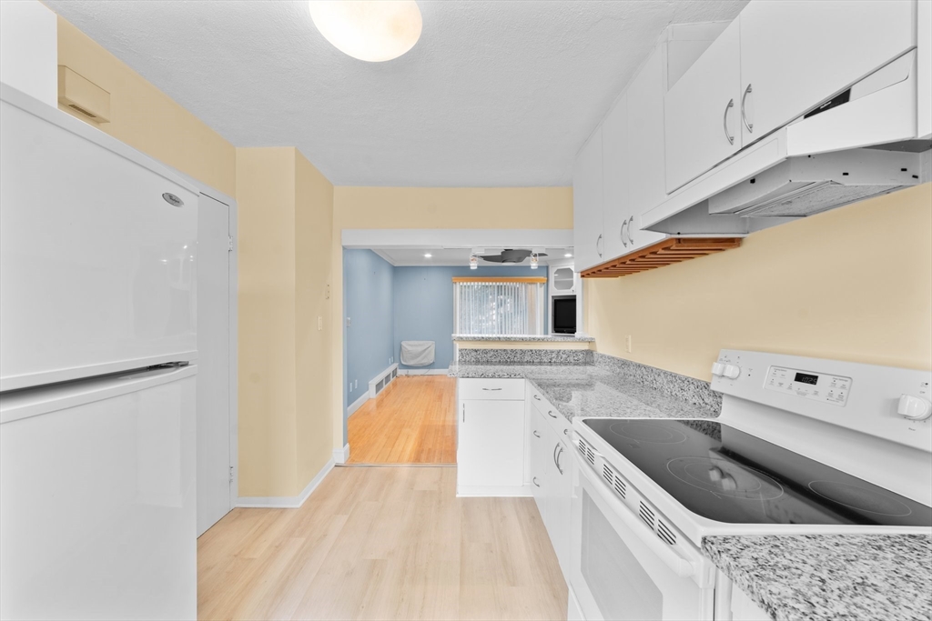 26 Westgate Road, Unit 264 Chestnut Hill, MA 02467 - Photo 10 of 30 a kitchen with a sink a stove top oven and cabinets