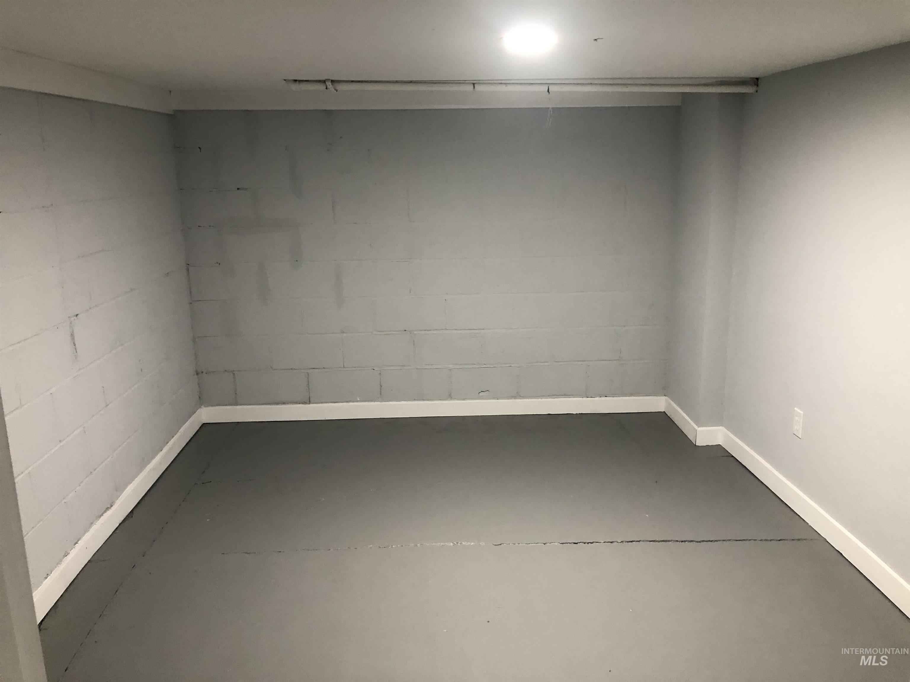 717 10th Street Clarkston, WA 99403 - Photo 18 of 23 Finished basement with concrete block wall and baseboards