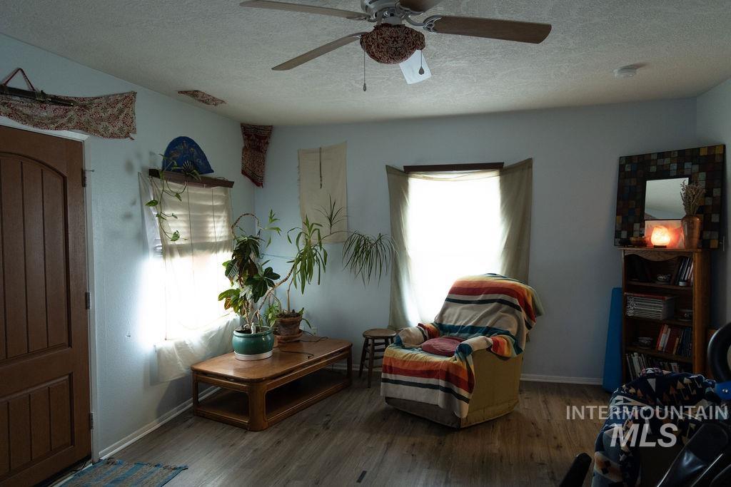 5420 West Targee Street Boise, ID 83705 - Photo 11 of 17 Sitting room featuring a textured ceiling, wood finished floors, and ceiling fan