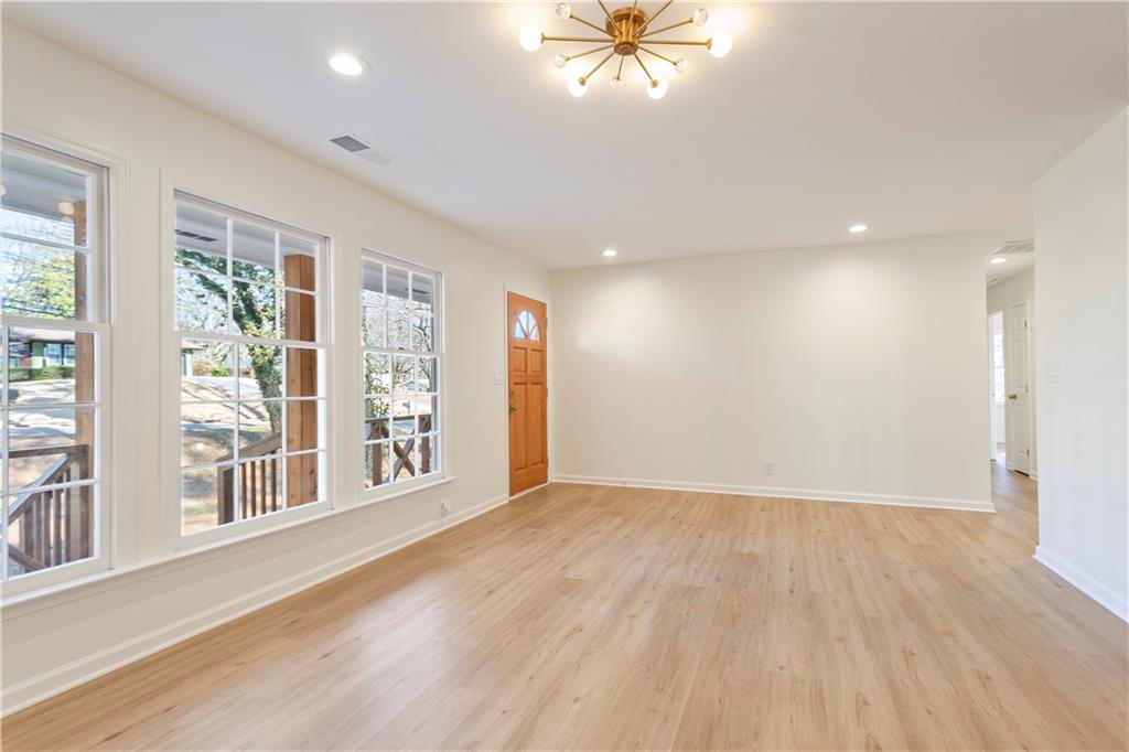 626 Reed Road Smyrna, GA 30082 - Photo 12 of 40 a view of an empty room with a window and wooden floor
