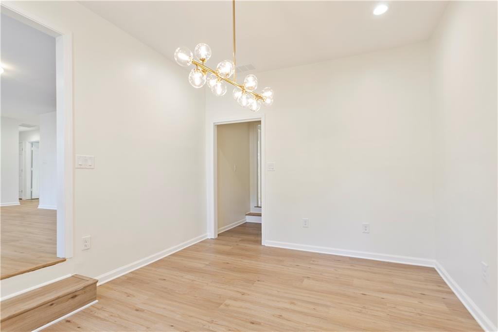 626 Reed Road Smyrna, GA 30082 - Photo 15 of 40 a view of an empty room with wooden floor