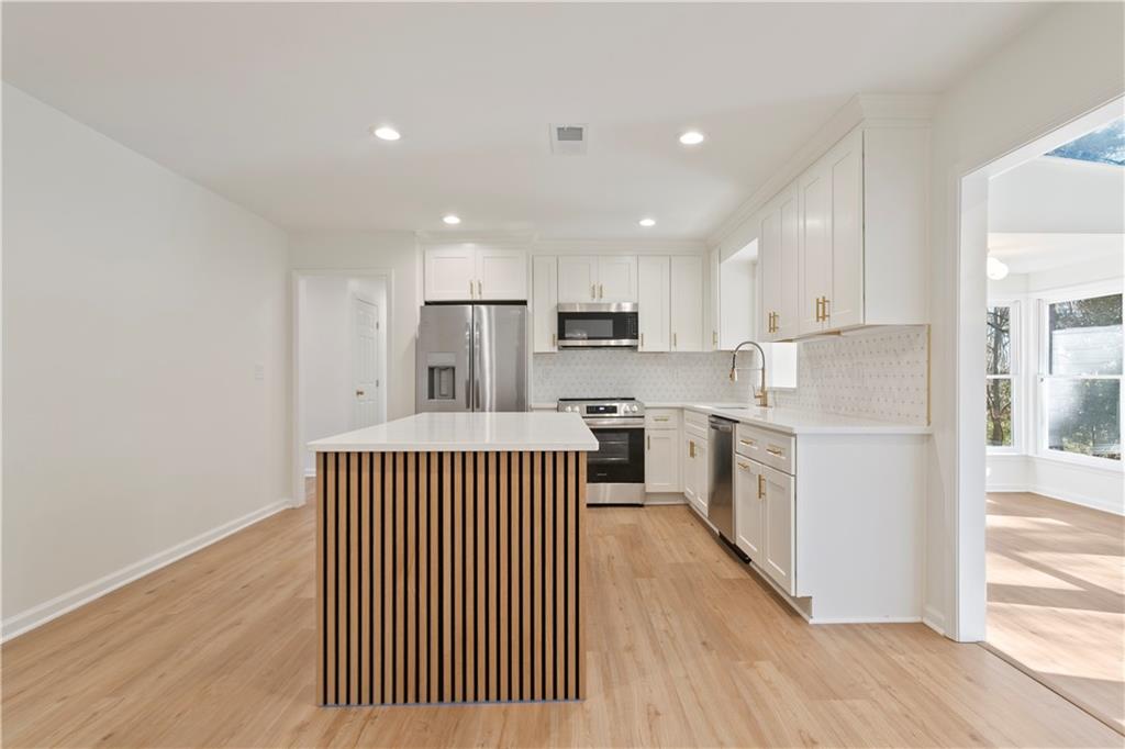 626 Reed Road Smyrna, GA 30082 - Photo 18 of 40 a kitchen with a refrigerator and a stove top oven