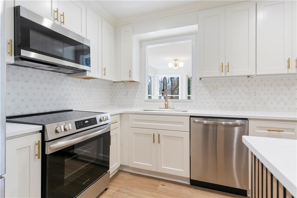 626 Reed Road Smyrna, GA 30082 - Photo 19 of 40 a kitchen with cabinets stainless steel appliances and wooden floor