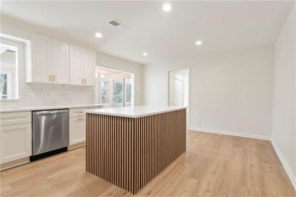 626 Reed Road Smyrna, GA 30082 - Photo 20 of 40 a kitchen with granite countertop white cabinets and wooden floor