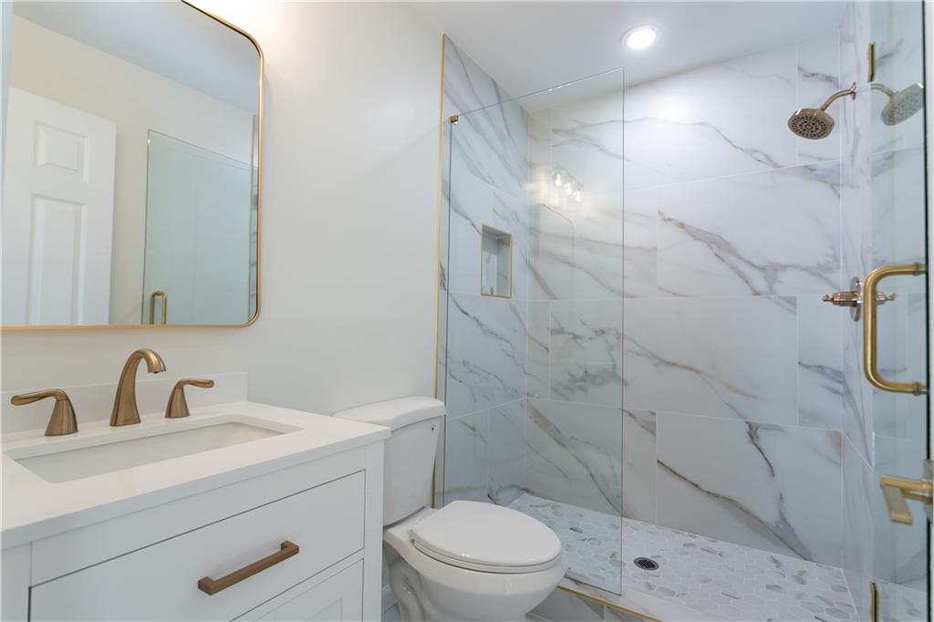 626 Reed Road Smyrna, GA 30082 - Photo 30 of 40 a bathroom with a sink toilet and shower