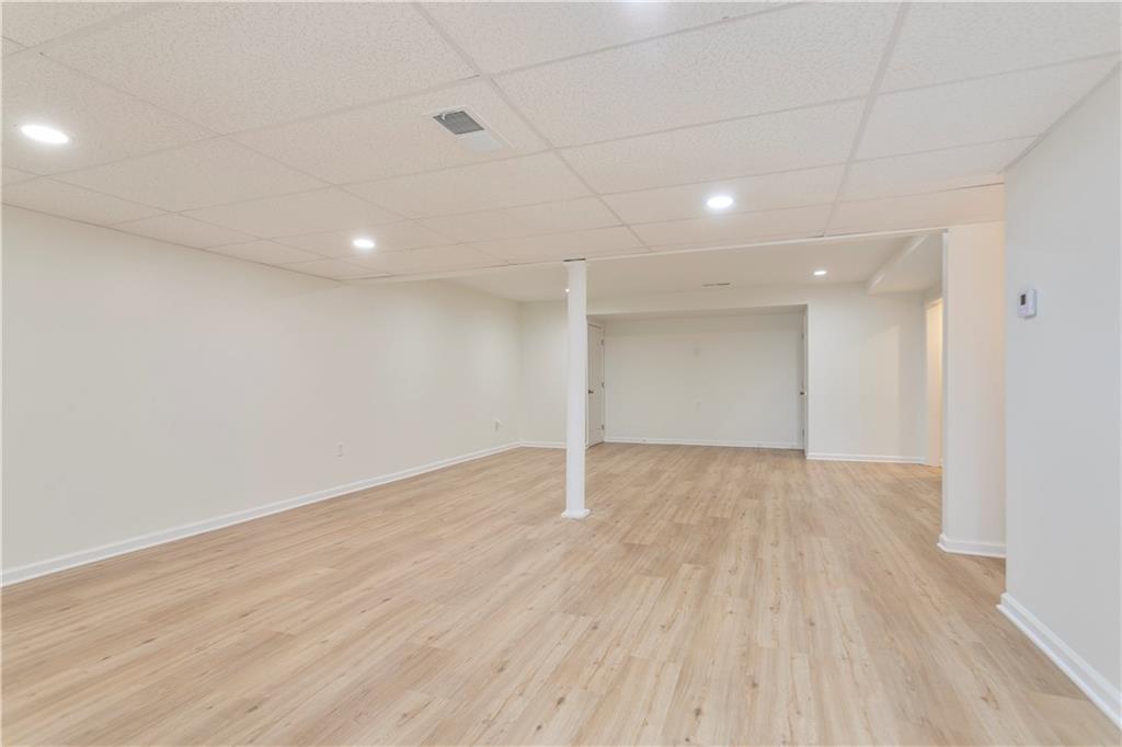 626 Reed Road Smyrna, GA 30082 - Photo 33 of 40 an empty room with wooden floor and windows