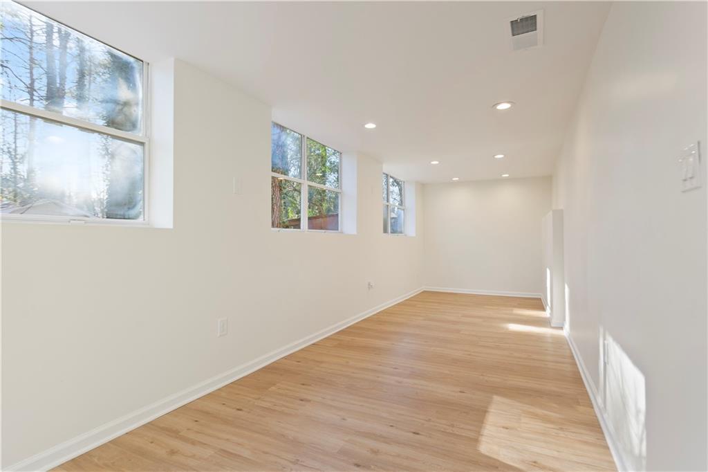 626 Reed Road Smyrna, GA 30082 - Photo 34 of 40 a view of an empty room with wooden floor and a window