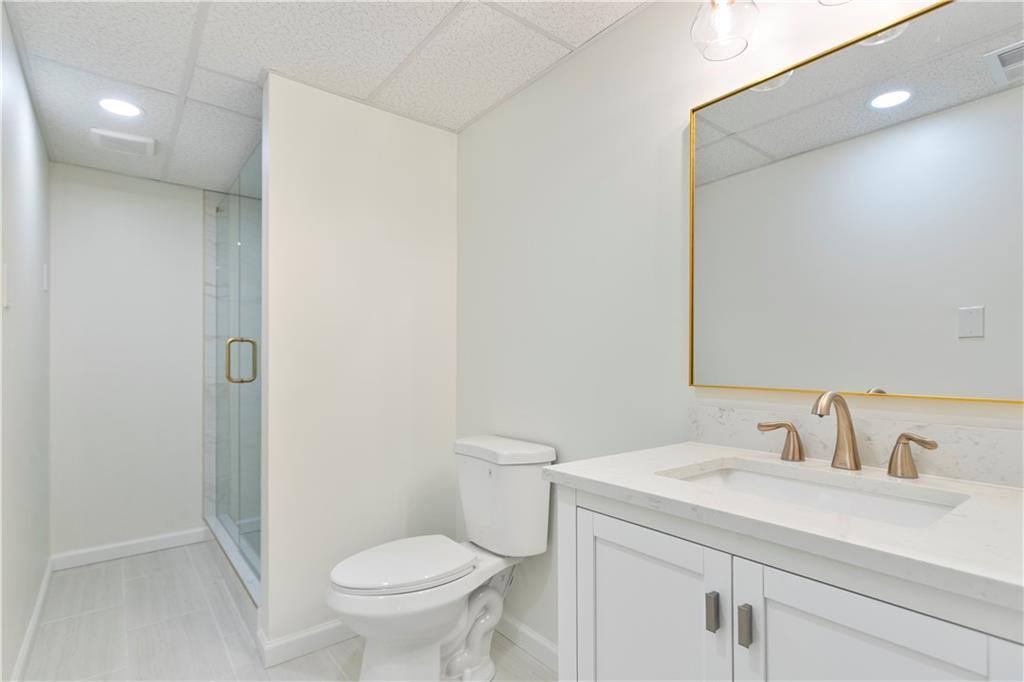 626 Reed Road Smyrna, GA 30082 - Photo 36 of 40 a bathroom with a granite countertop sink a toilet and a mirror