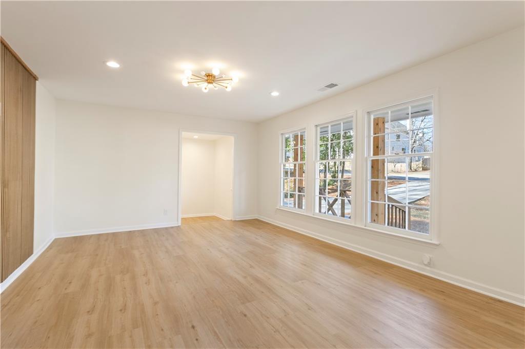626 Reed Road Smyrna, GA 30082 - Photo 10 of 40 a view of an empty room with a window and wooden floor