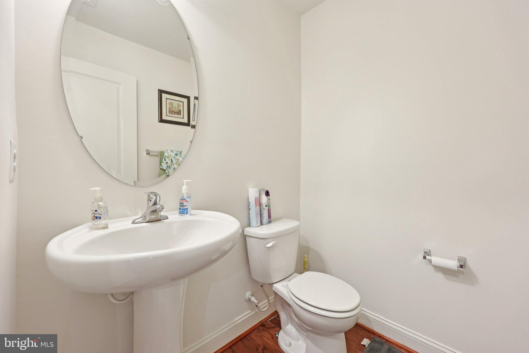 7206 Wood Meadow Way Lanham, MD 20706 - Photo 11 of 61 a bathroom with a toilet a sink and mirror