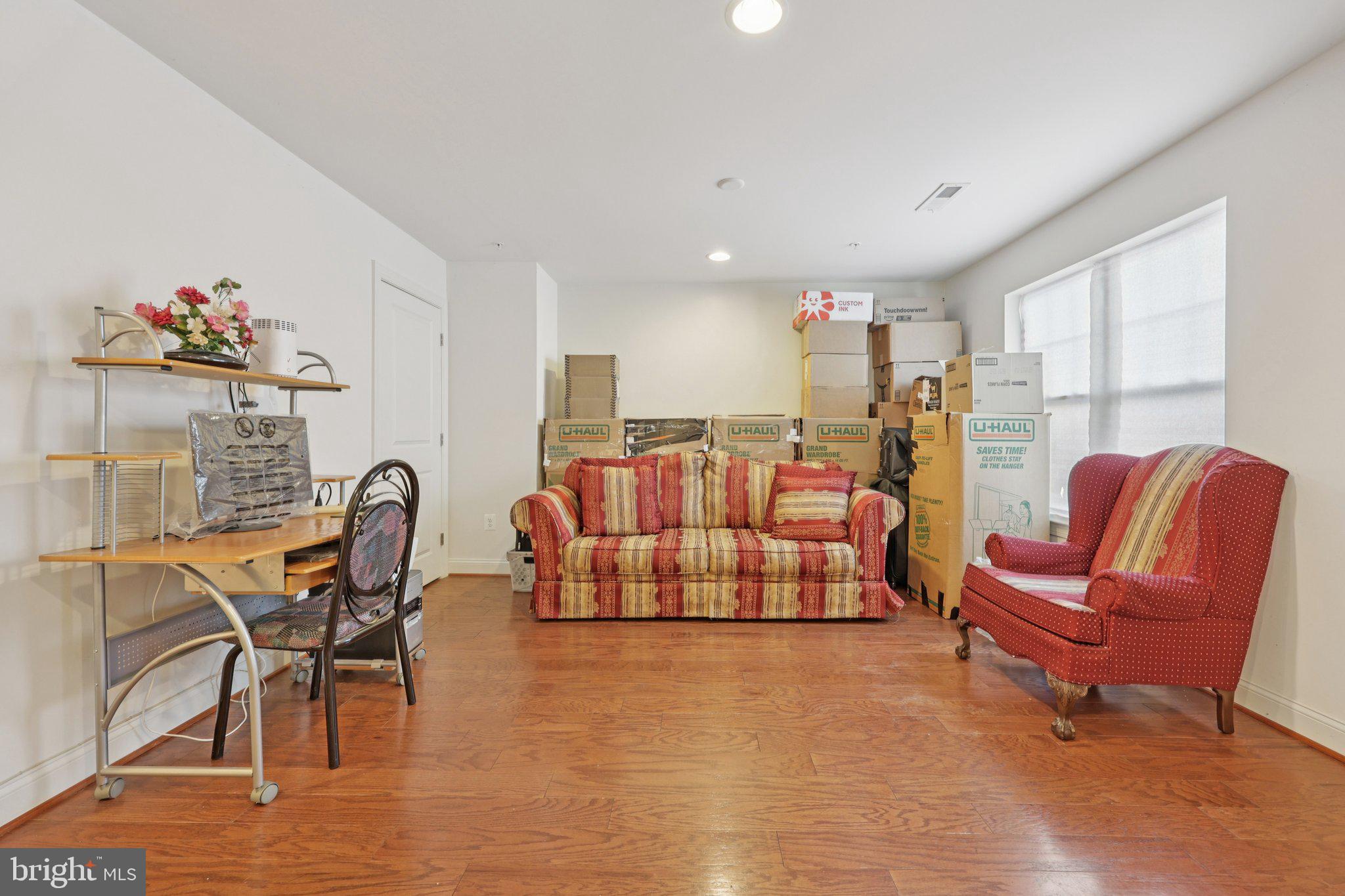 7206 Wood Meadow Way Lanham, MD 20706 - Photo 16 of 61 a living room with furniture and a dining table with a kitchen view