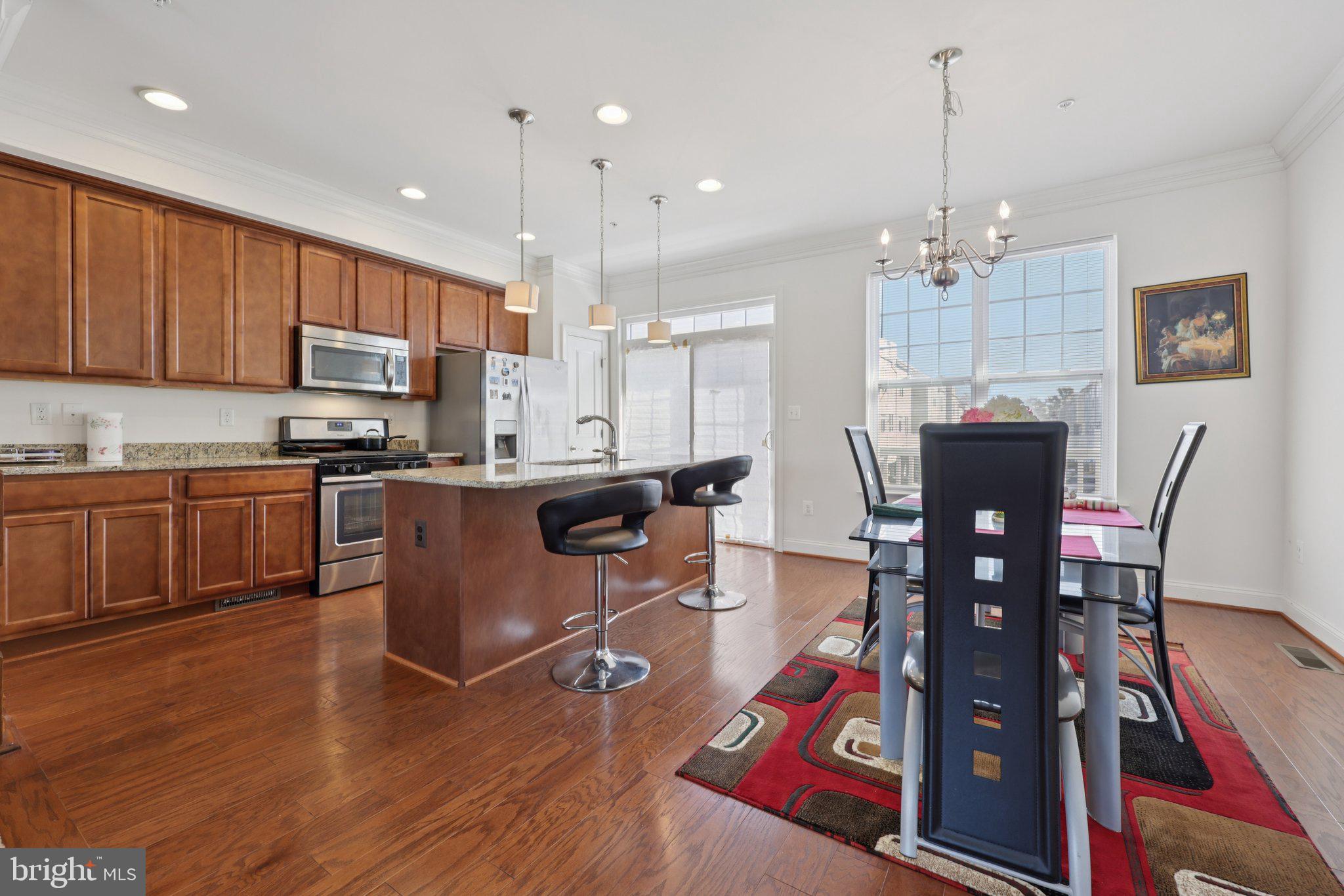 7206 Wood Meadow Way Lanham, MD 20706 - Photo 27 of 61 a living room with stainless steel appliances kitchen island granite countertop furniture wooden floor and a kitchen view