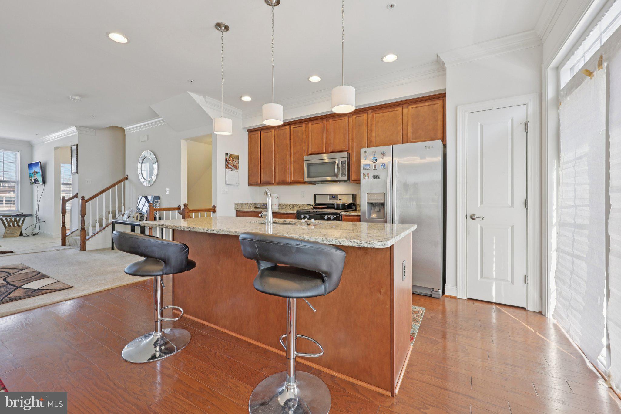 7206 Wood Meadow Way Lanham, MD 20706 - Photo 30 of 61 a kitchen with stainless steel appliances granite countertop a stove a sink and a refrigerator