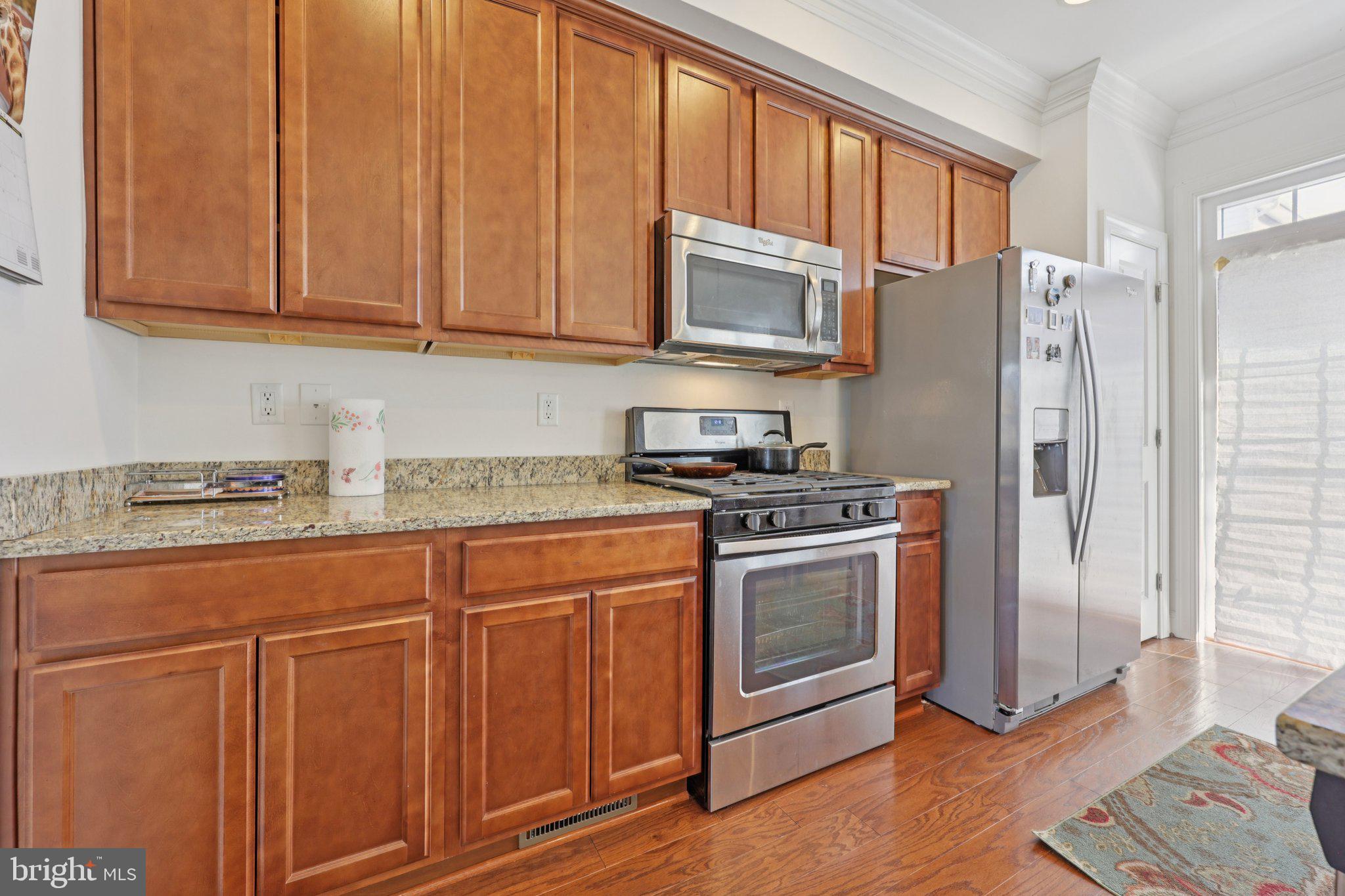 7206 Wood Meadow Way Lanham, MD 20706 - Photo 32 of 61 a kitchen with stainless steel appliances granite countertop a refrigerator stove and sink