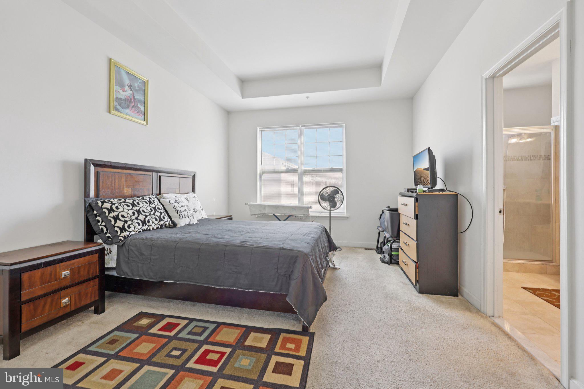 7206 Wood Meadow Way Lanham, MD 20706 - Photo 38 of 61 a bedroom with a bed and wooden floor