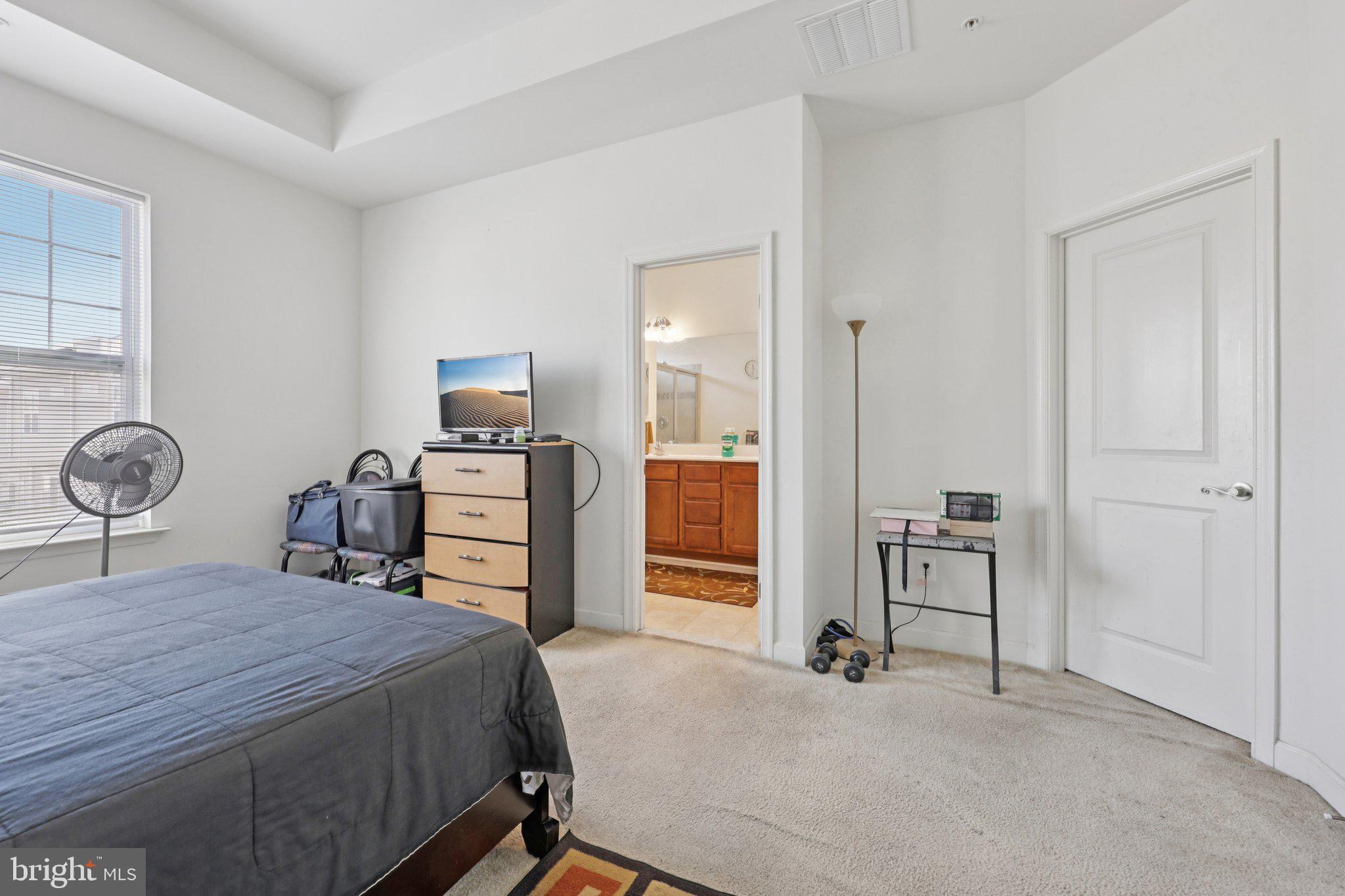 7206 Wood Meadow Way Lanham, MD 20706 - Photo 39 of 61 a bedroom with a bed and a chandelier