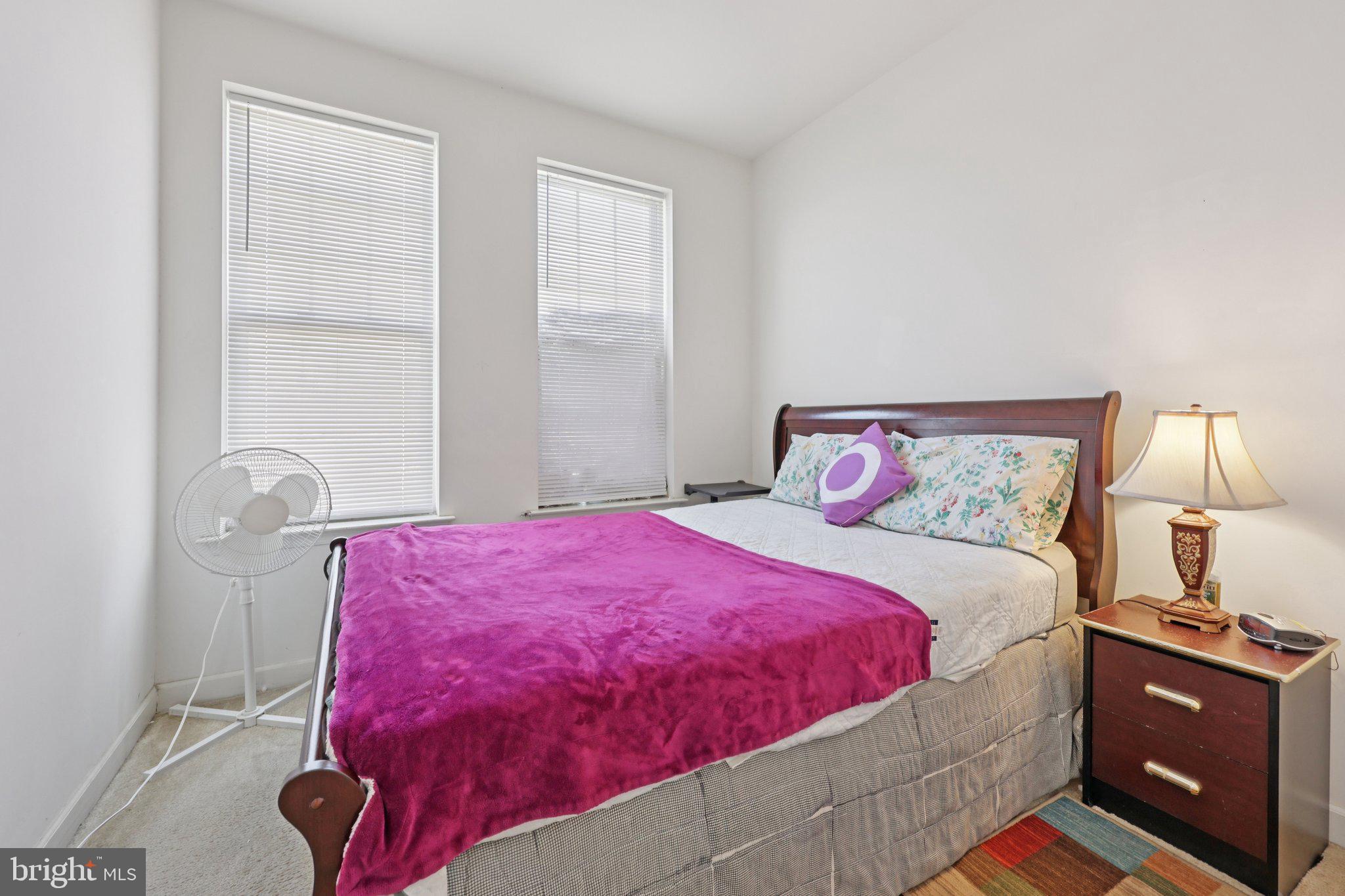 7206 Wood Meadow Way Lanham, MD 20706 - Photo 46 of 61 a bedroom with a bed and a lamp