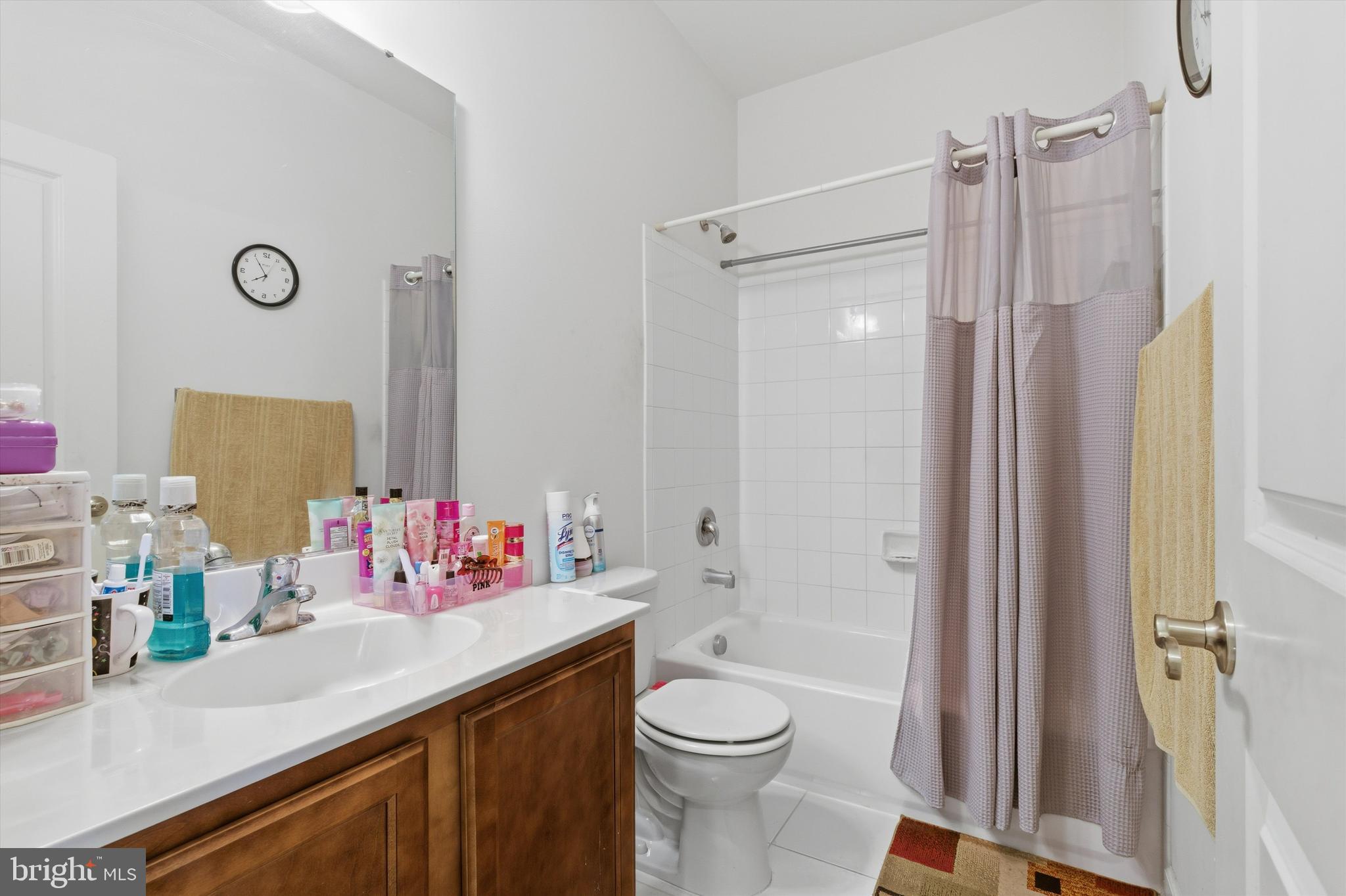 7206 Wood Meadow Way Lanham, MD 20706 - Photo 50 of 61 a bathroom with a sink vanity mirror and toilet