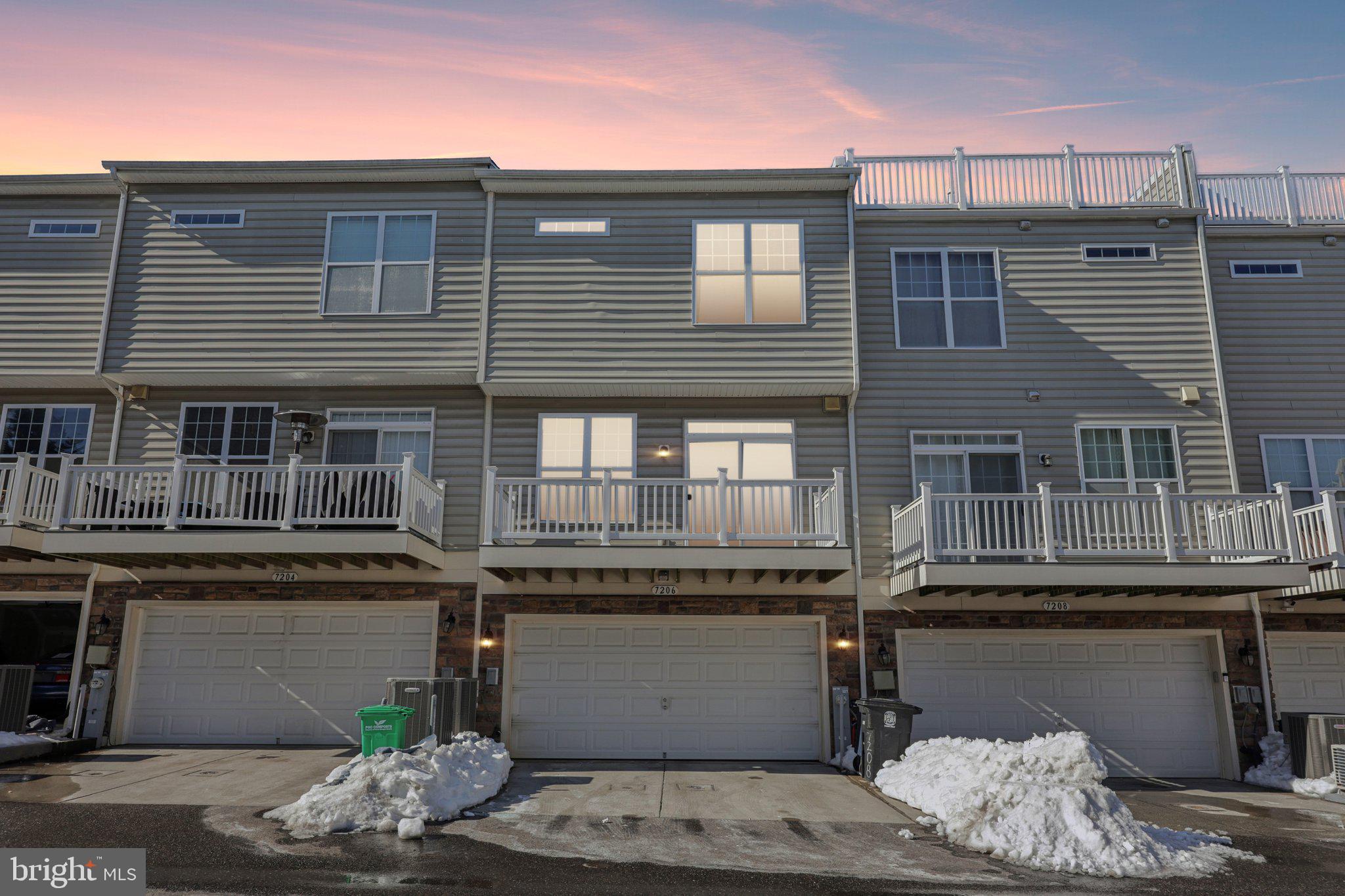7206 Wood Meadow Way Lanham, MD 20706 - Photo 5 of 61 a front view of a house with a table and chairs