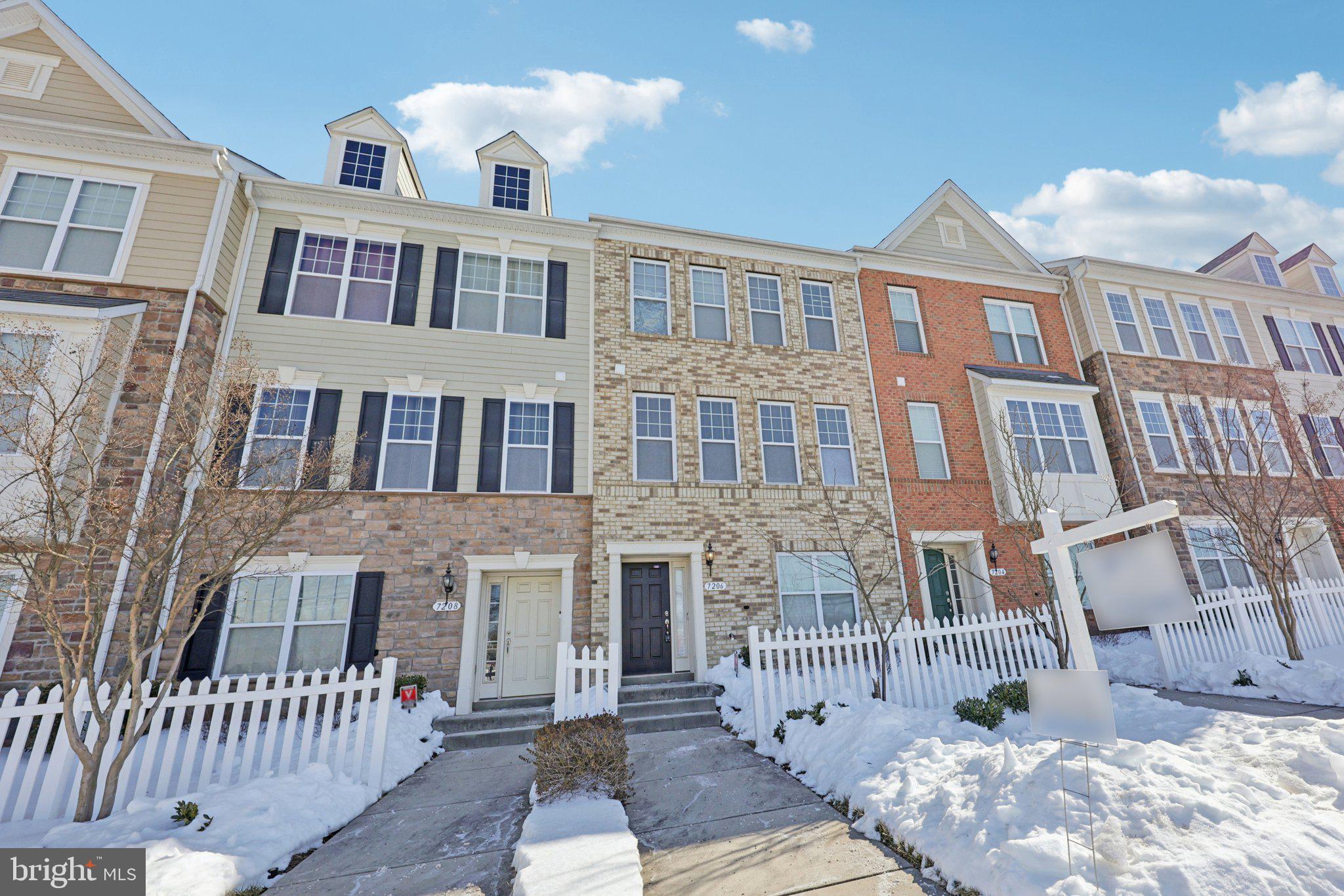 7206 Wood Meadow Way Lanham, MD 20706 - Photo 7 of 61 a front view of a house with a yard