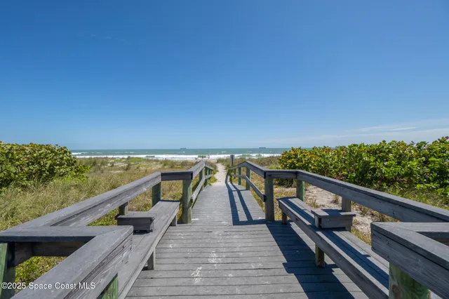 a view of a chairs and table in the balcony