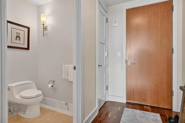 a bathroom with a toilet and a shower