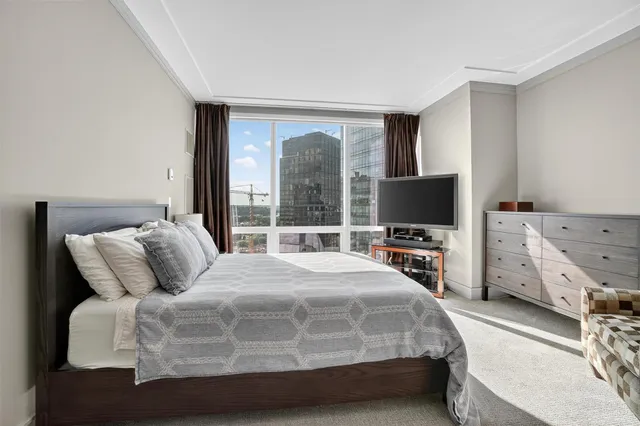 a bedroom with a bed and a flat screen tv