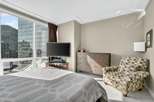 a bedroom with bed and large window