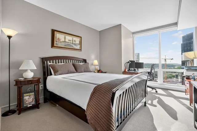 a bedroom with a bed and a lamp