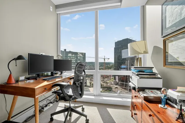 a view of workspace with wooden floor windows