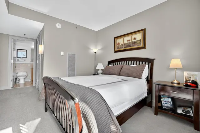 a bedroom with a bed and a lamp