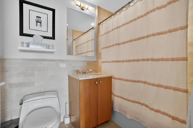 a view of bathroom with a toilet sink and mirror