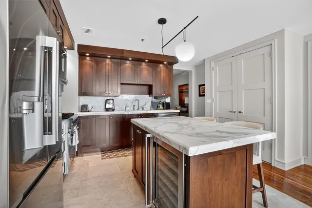 a kitchen with a stove a refrigerator and a sink