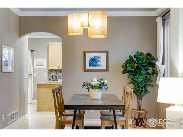 a view of a dining room with furniture and a potted plant