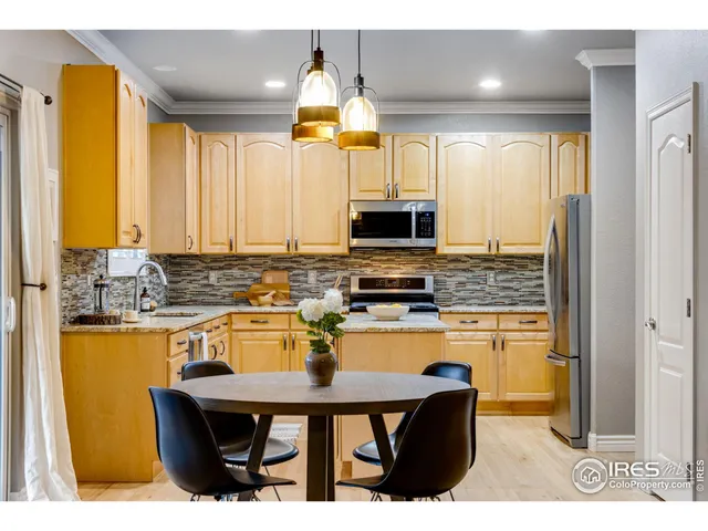 a kitchen with a sink appliances and cabinets