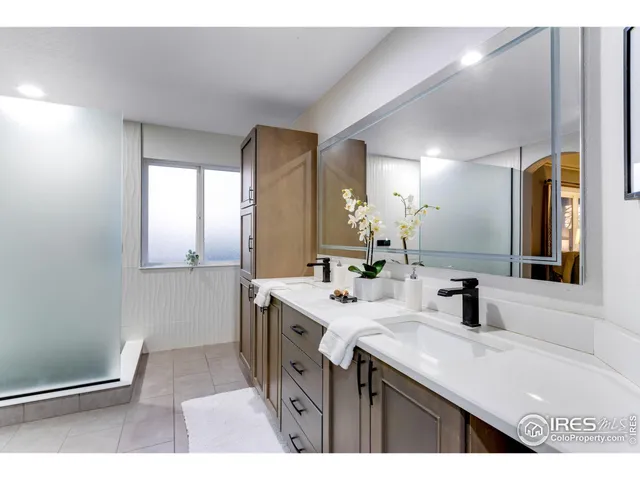 a bathroom with a sink a mirror and a vanity