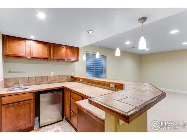 a kitchen with a sink cabinets and window