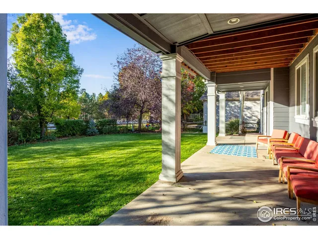 a view of a backyard with table and chairs and garden