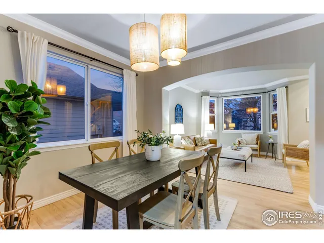 a view of a dining room with furniture a chandelier and wooden floor