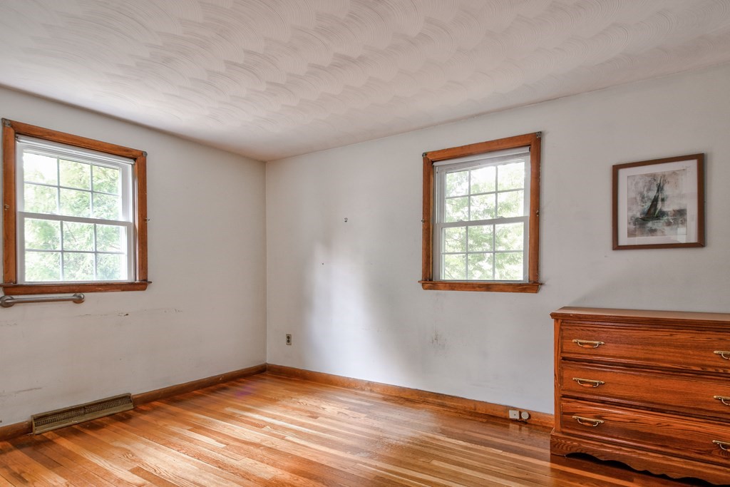 186 Edmands Road Framingham, MA 01701 - Photo 18 of 26 a view of an empty room with wooden floor and a window