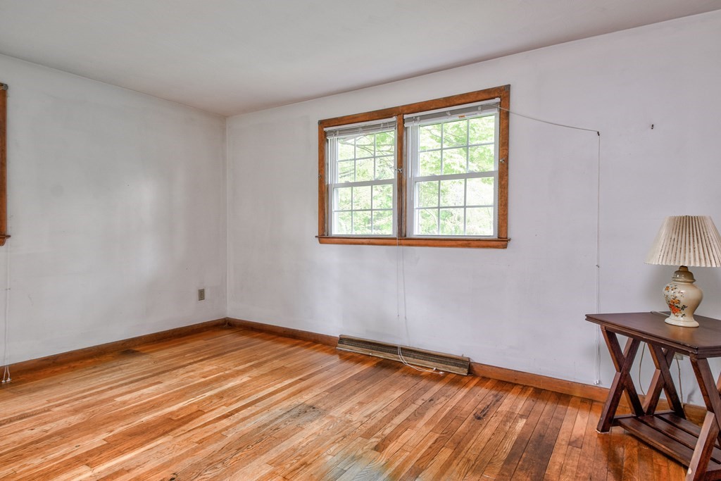 186 Edmands Road Framingham, MA 01701 - Photo 20 of 26 a view of an empty room with wooden floor and a window