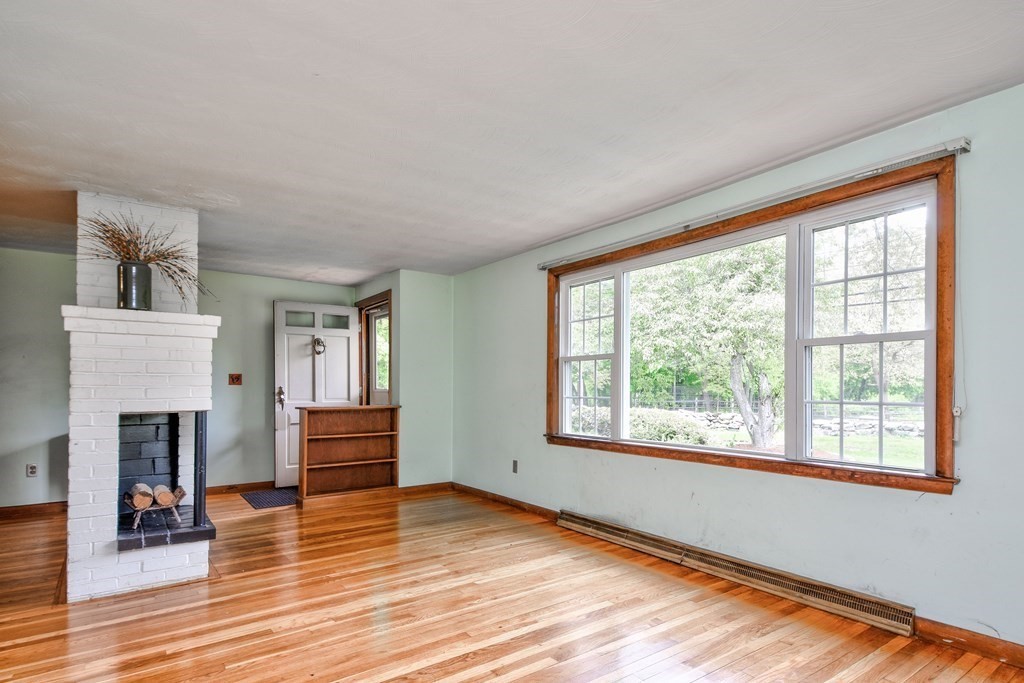 186 Edmands Road Framingham, MA 01701 - Photo 2 of 26 a view of empty room with wooden floor and fireplace