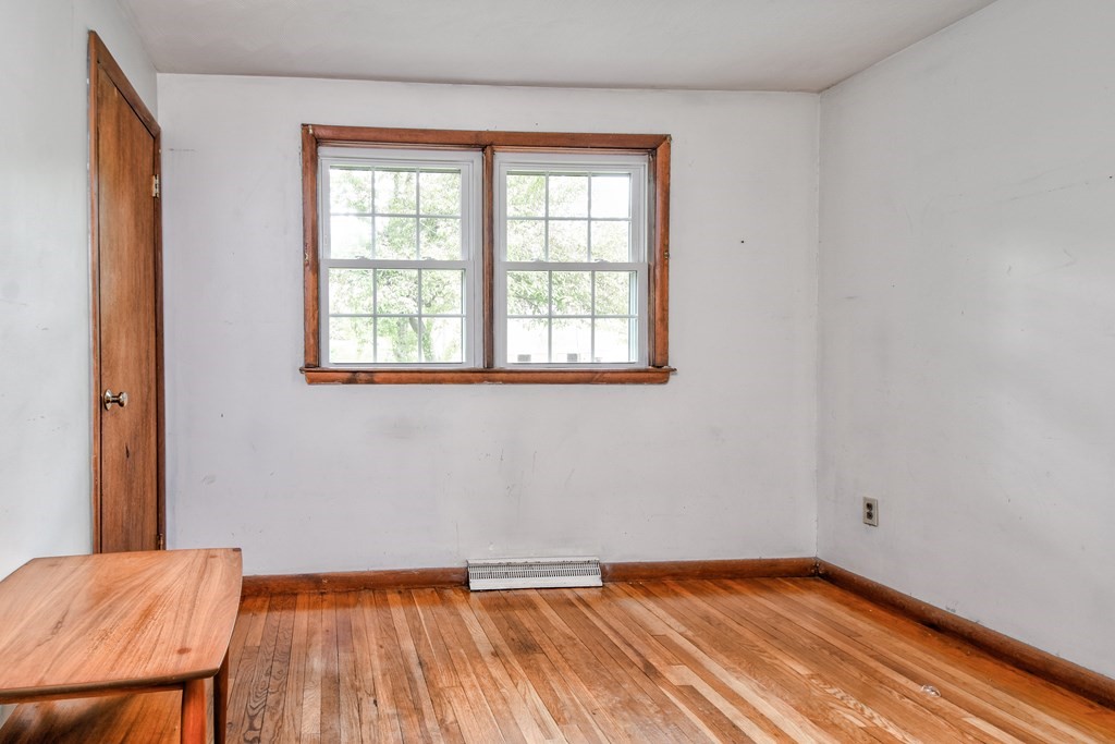 186 Edmands Road Framingham, MA 01701 - Photo 21 of 26 a view of an empty room with wooden floor and a window