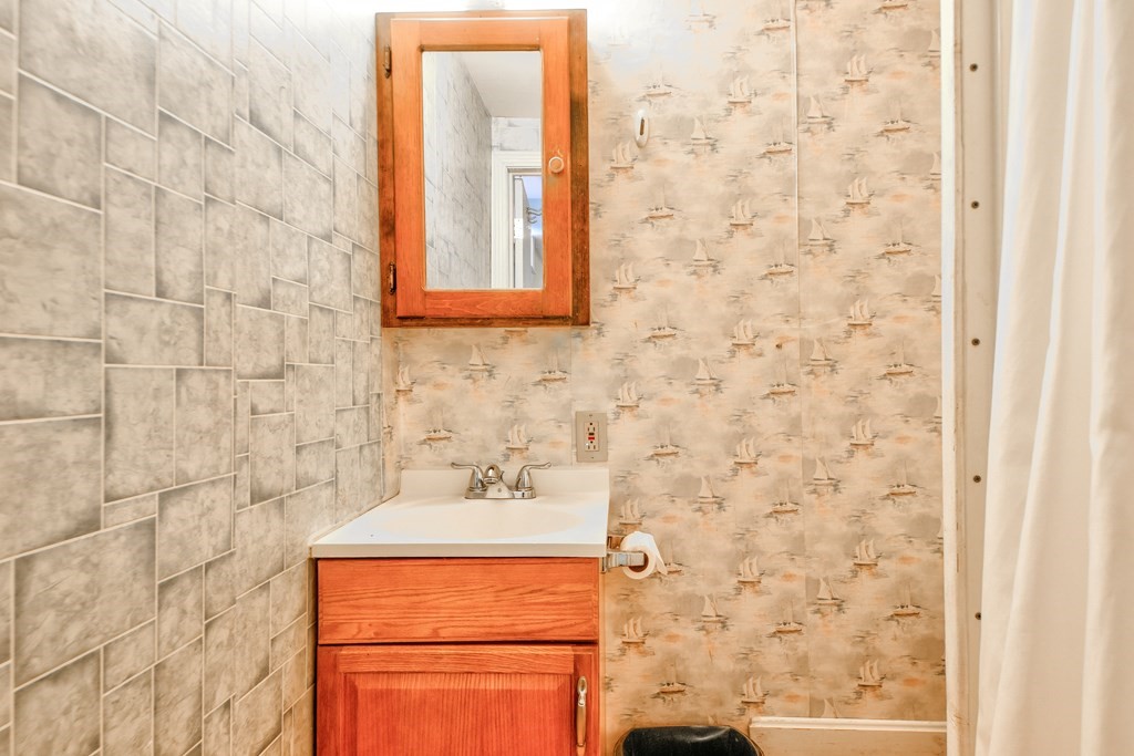 186 Edmands Road Framingham, MA 01701 - Photo 25 of 26 a bathroom with a sink and a shower curtain