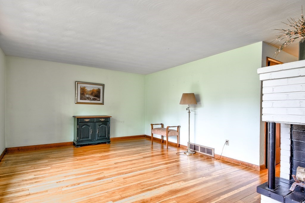 186 Edmands Road Framingham, MA 01701 - Photo 3 of 26 a view of a livingroom with wooden floor and a fireplace