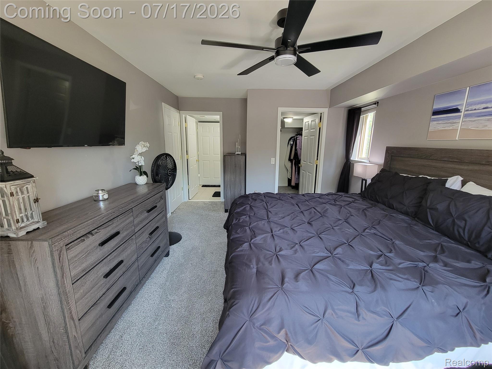 1655 Riverside Drive, Unit 10 Rochester, MI 48309 - Photo 31 of 44 Bedroom featuring light gray wall paint, light gray carpet, and a modern ceiling fan with black blades