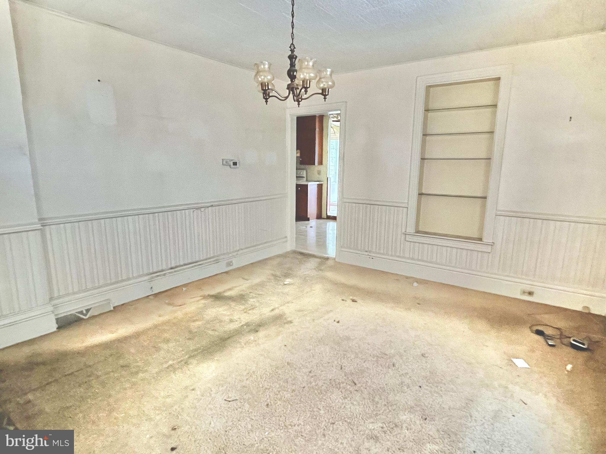 203 North Cedar Street Lititz, PA 17543 - Photo 3 of 34 en empty room with a fireplace and chandelier