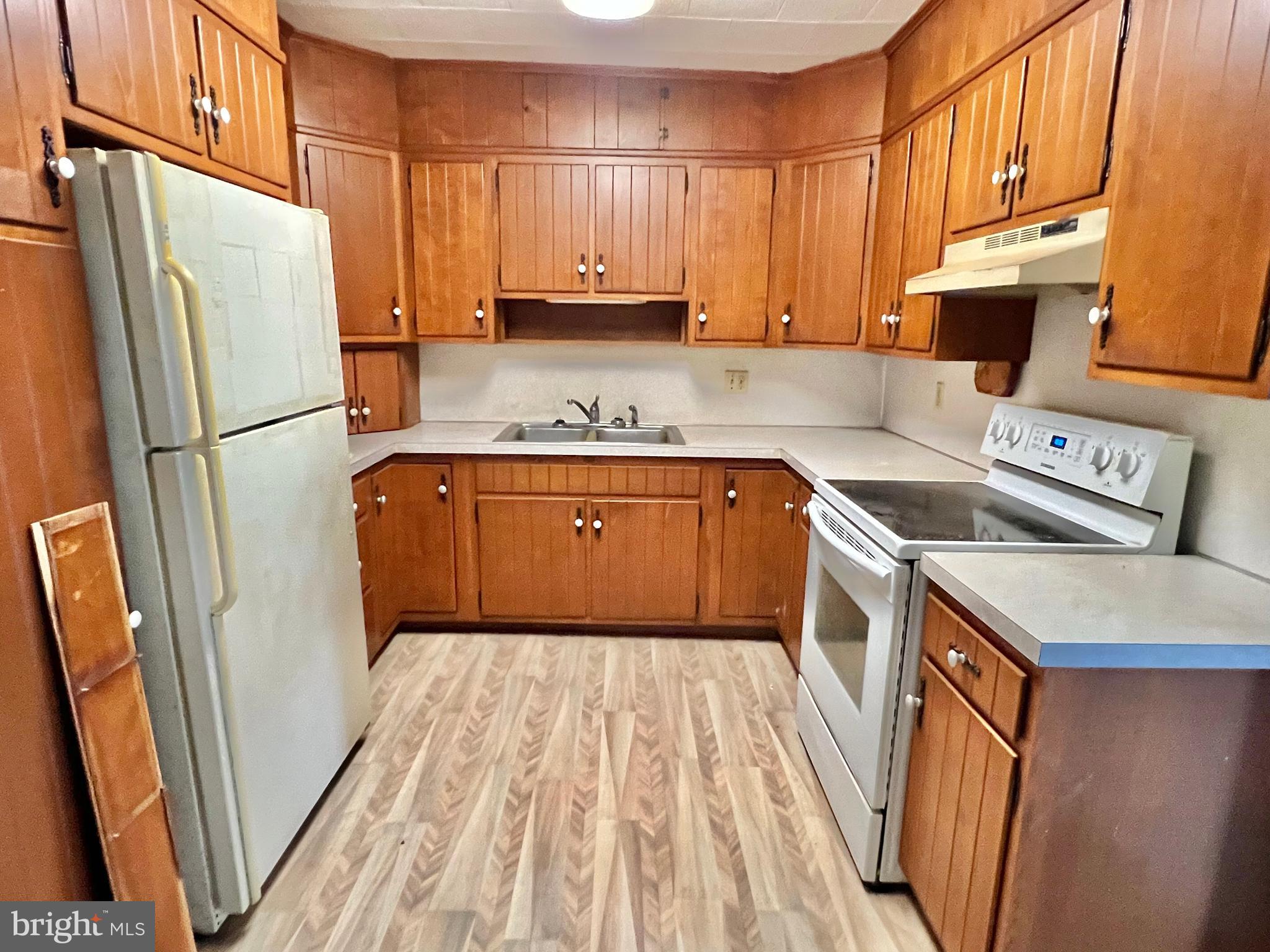 203 North Cedar Street Lititz, PA 17543 - Photo 8 of 34 a kitchen with stainless steel appliances granite countertop a refrigerator a sink dishwasher a stove top oven a refrigerator and white cabinets with wooden floor